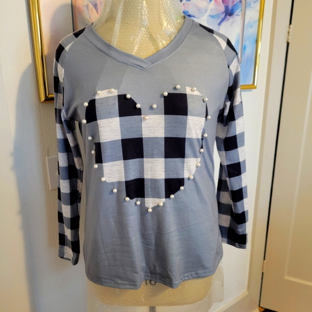 Blouse, part plaid grey, black, and white, with pearl accents on front.